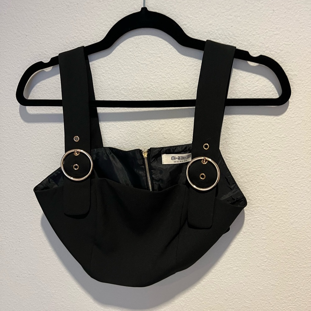 black crop top with gold buckle straps